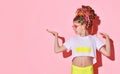 Cute little girl in rose sunglasses with multicolored african braids jumping and dancing full of joy. Royalty Free Stock Photo