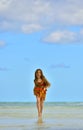 Cute little girl running on beach in sunset Royalty Free Stock Photo