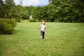 A cute little girl running on the bright green grass Royalty Free Stock Photo