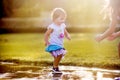 Cute little girl running through puddles Royalty Free Stock Photo