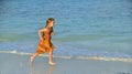 Cute little girl running on sandy beach in sunset Royalty Free Stock Photo