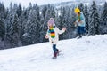 Cute little girl running on snow winter nature. Funny kid playing with snow in winter clothes. Children winter outdoors Royalty Free Stock Photo