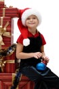 Cute little girl in a Santa Claus cap with Christmas gifts, isolated Royalty Free Stock Photo