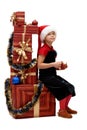 Cute little girl in a Santa Claus cap with Christmas gifts, isolated Royalty Free Stock Photo