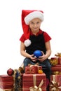 Cute little girl in a Santa Claus cap with Christmas gifts, isolated Royalty Free Stock Photo