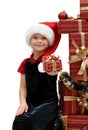 Cute little girl in a Santa Claus cap with Christmas gifts, isolated Royalty Free Stock Photo