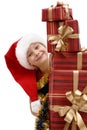 Cute little girl in a Santa Claus cap with Christmas gifts, isolated Royalty Free Stock Photo