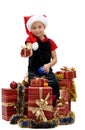 Cute little girl in a Santa Claus cap with Christmas gifts, isolated Royalty Free Stock Photo