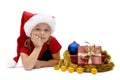 Cute little girl in a Santa Claus cap with Christmas gifts, isolated Royalty Free Stock Photo