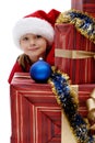 Cute little girl in a Santa Claus cap with Christmas gifts, isolated Royalty Free Stock Photo