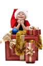 Cute little girl in a Santa Claus cap with Christmas gifts, isolated Royalty Free Stock Photo