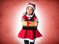 Cute Little Girl in Santa Claus costume holding a Christmas Box