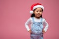 Cute little girl in santa hat looking happy and sweet Royalty Free Stock Photo