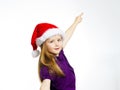 Cute little girl in santa red hat showing by hand Royalty Free Stock Photo