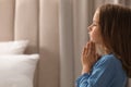 Cute little girl saying bedtime prayer at home. Space for text Royalty Free Stock Photo