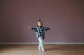 Cute little girl in shirt and jeans in dance studio Royalty Free Stock Photo