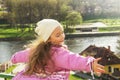 Cute little girl shone with happiness, curly hair, charming smile in the sunny spring day