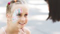 Cute little girl showing her beautiful face painting to mom Royalty Free Stock Photo