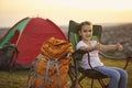 Cute little girl showing thumbs up gesture during camping trip in mountains. Child enjoying summer vacation Royalty Free Stock Photo