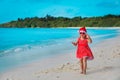 Cute little girl sing and clap hands, celebrating christmas on tropical beach Royalty Free Stock Photo