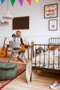 Little girl sitting at desk in her stylish vintage bedroom with workspace