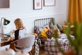 Little girl sitting at desk making homework in her stylish vintage bedroom with workspace