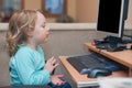 Little girl playing with computer keyboard and mouse Royalty Free Stock Photo