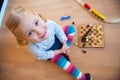 Cute little girl sitting on floor and playing Royalty Free Stock Photo