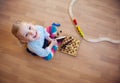 Cute little girl sitting on floor and playing Royalty Free Stock Photo