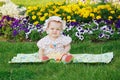 Cute little girl sitting on a flowers meadow Royalty Free Stock Photo