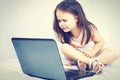 Cute little girl sitting with a laptop Royalty Free Stock Photo