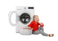 Cute little girl sitting near basket with laundry Royalty Free Stock Photo