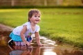 Cute little girl sitting in puddle Royalty Free Stock Photo