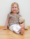 Cute little girl sitting with teddy bear Royalty Free Stock Photo