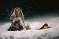 Cute little girl warming herself by the fire in the winter evening Royalty Free Stock Photo