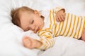 Cute little girl sleeping peacefully on bed, baby having good dream and feeling comfortable, closeup shot Royalty Free Stock Photo