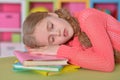 Cute little girl sleeping on pile of books Royalty Free Stock Photo