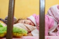 Cute little girl is sleeping on the second floor of a bunk bed