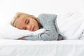 Cute little girl sleeping on white pillow in gray pajamas havin Royalty Free Stock Photo