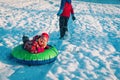 Cute little girl slide in winter snow, family have fun outside Royalty Free Stock Photo