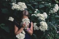 Cute little girl smelling lilac Royalty Free Stock Photo