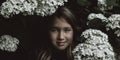 Cute little girl smelling lilac Royalty Free Stock Photo