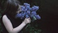 Cute little girl smelling lilac Royalty Free Stock Photo