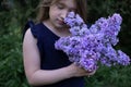 Cute little girl smelling lilac Royalty Free Stock Photo