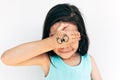 Cute little girl smiles and covers her eyes with both hands with drawing funny eyes on it. Adorable child having fun and playing Royalty Free Stock Photo