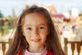 Cute little girl smiling in a park close up