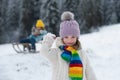 Cute little girl snowball fight on snow winter nature. Funny kid in winter clothes. Children play outdoors in snow. Kids Royalty Free Stock Photo