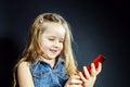 Cute little girl speaks using new cell phone. Royalty Free Stock Photo