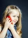 Cute little girl speaks using new cell phone. Royalty Free Stock Photo