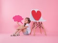 Cute little girl with speech icon on colored background